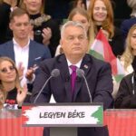 A boldogan tapsikoló Szabó Zsófival és a rózsafüzérrel imádkozó Eperjes Károllyal a háta mögött mondta el beszédét Orbán Viktor